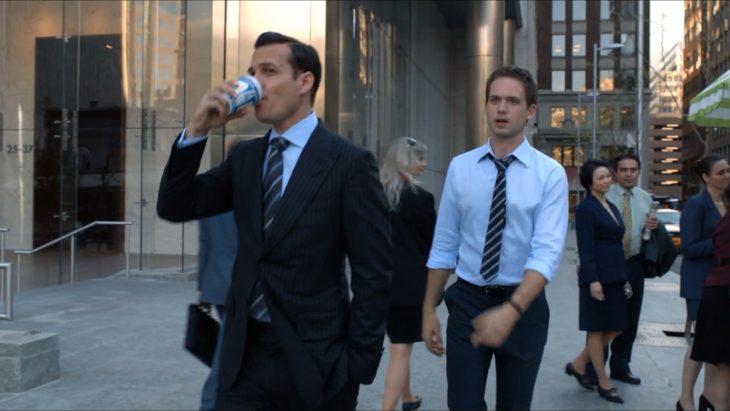 Gabriel Macht and Patrick J. Adams with an Anthora coffee cup on the TV show Suits